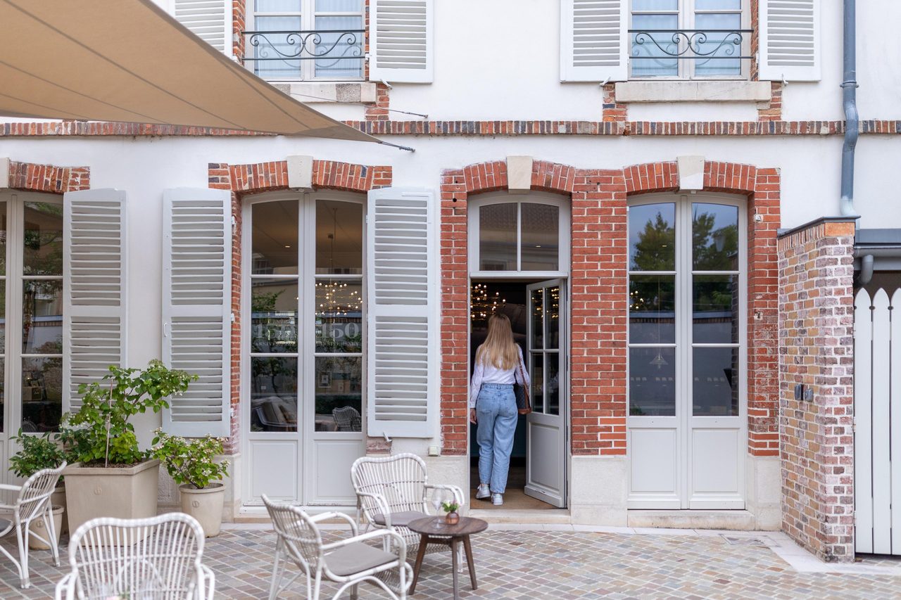 Sand-coloured sails over a cobbled courtyard, Épernay