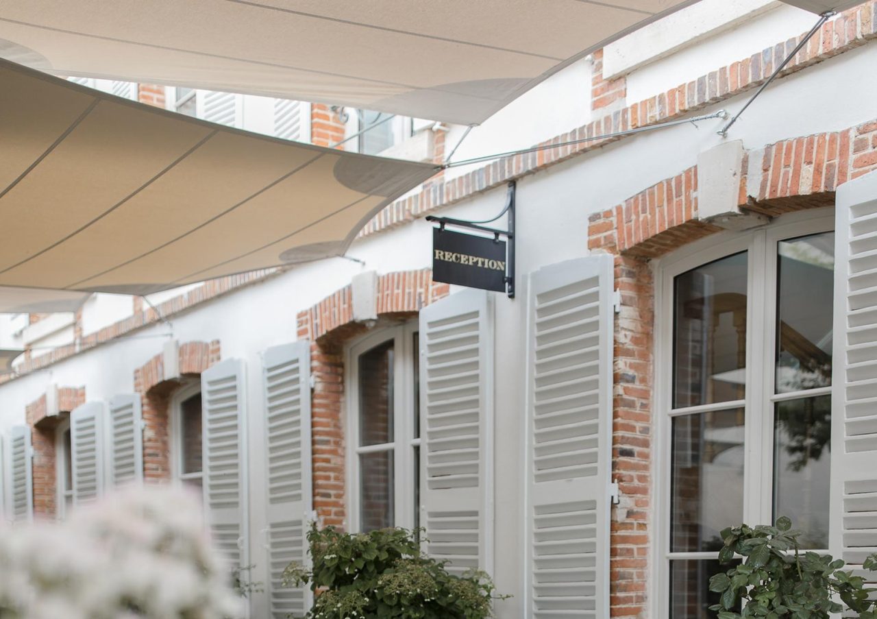Sand-coloured sails over a cobbled courtyard, Épernay